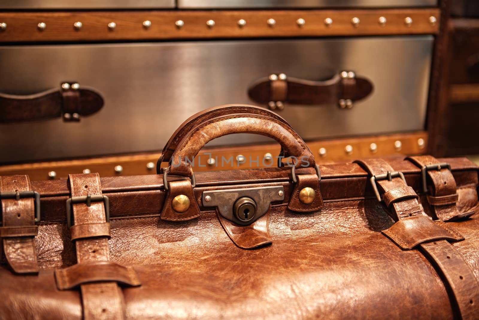 close-up fragment of locks and fasteners on the vintage leather suitcase brown