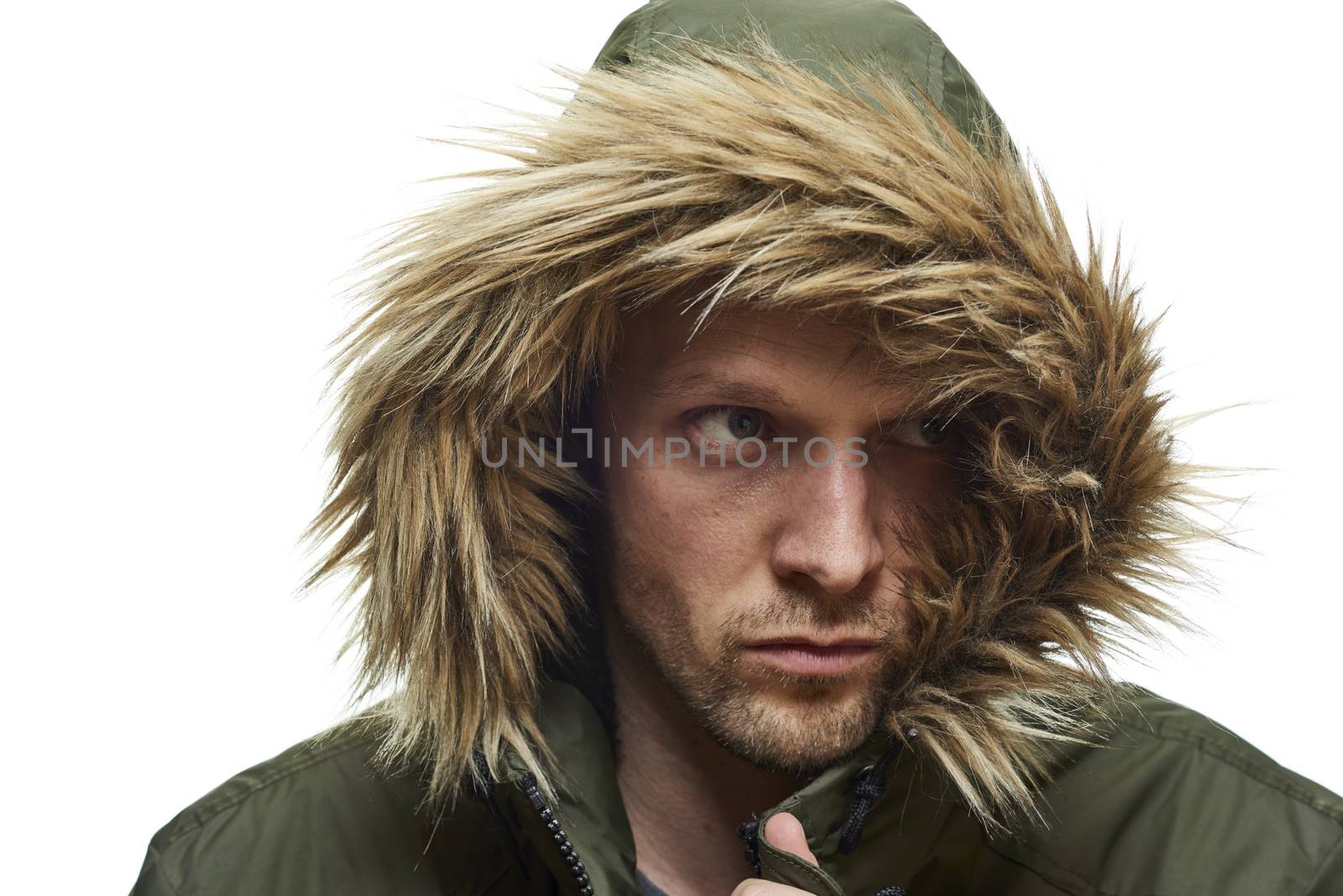 High key studio portrait of young adult caucasian model wearing winter coat with hood.