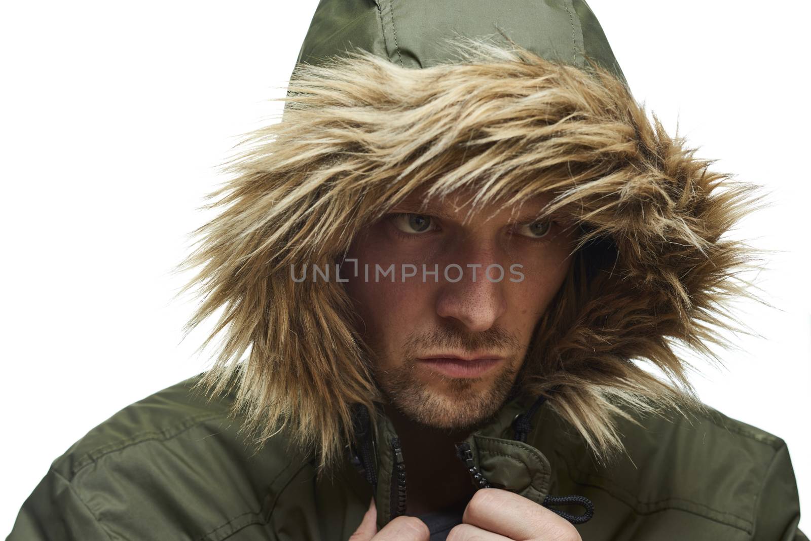 High key studio portrait of young adult caucasian model wearing winter coat with hood.