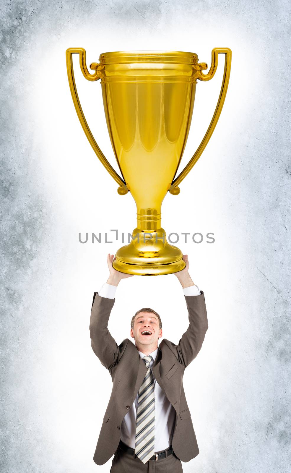 Businessman holding sport cup by cherezoff