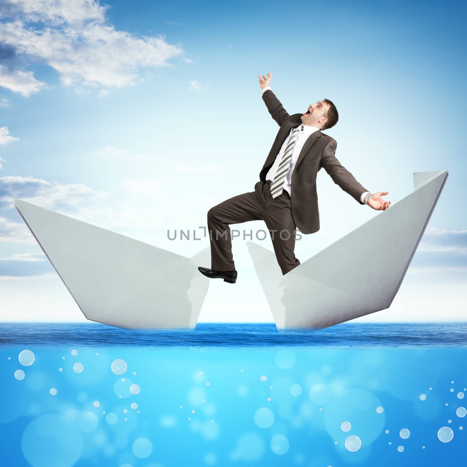 Businessman in broken paper boat in blue sea, business concept