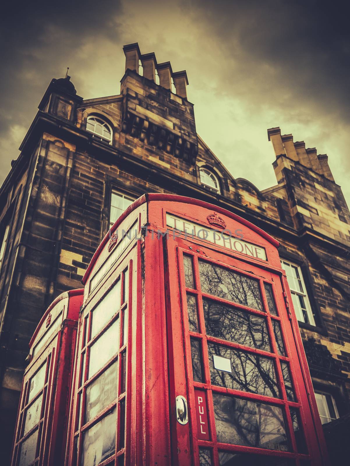 A Vintage British Phonebox In A British City (Edinburgh) Against Stormy Sky