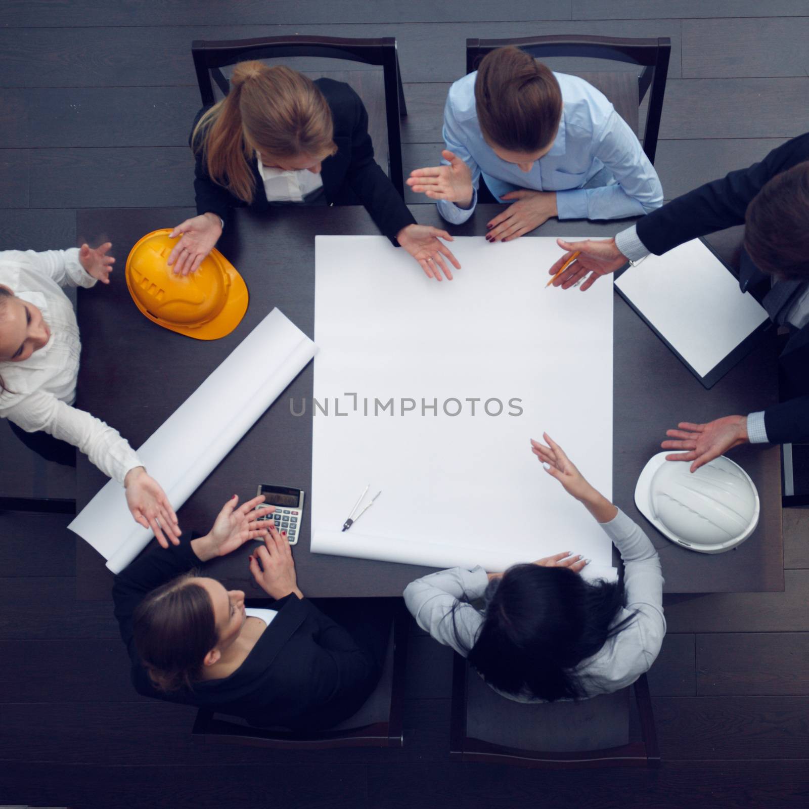 Top view of people around table in construction business meeting