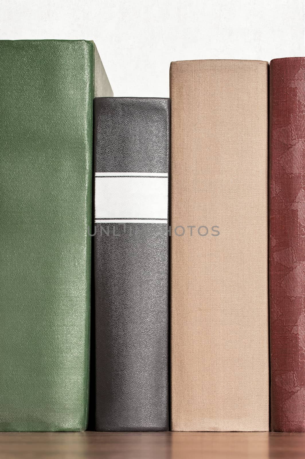 stack of books on the shelf by nejuras