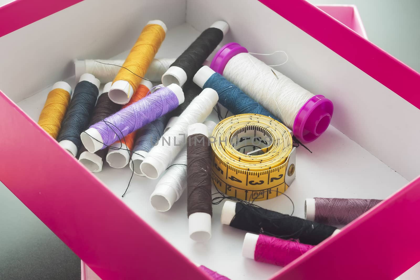 Set of colored threads for sewing and measuring tape