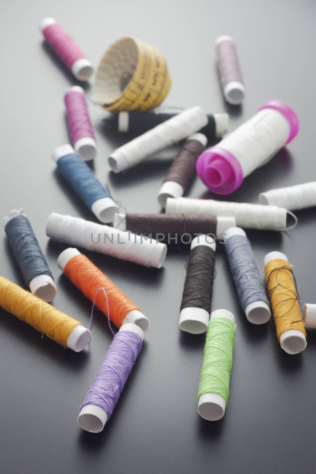 Spools of sewing thread isolated on gray by mailos