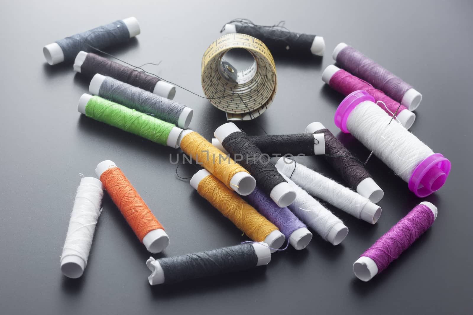 Spools of sewing thread isolated on gray by mailos