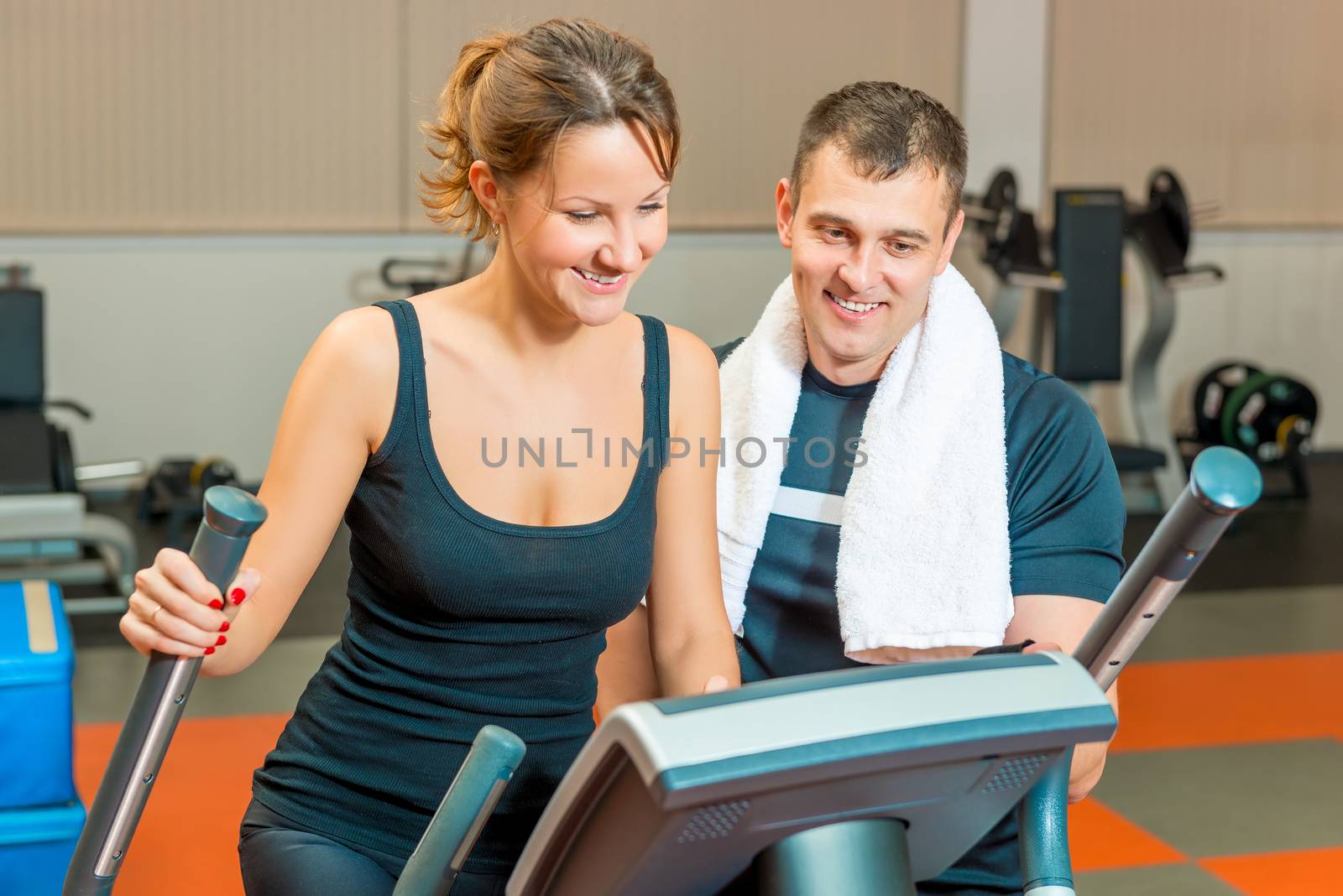 beautiful girl and personal trainer at the gym