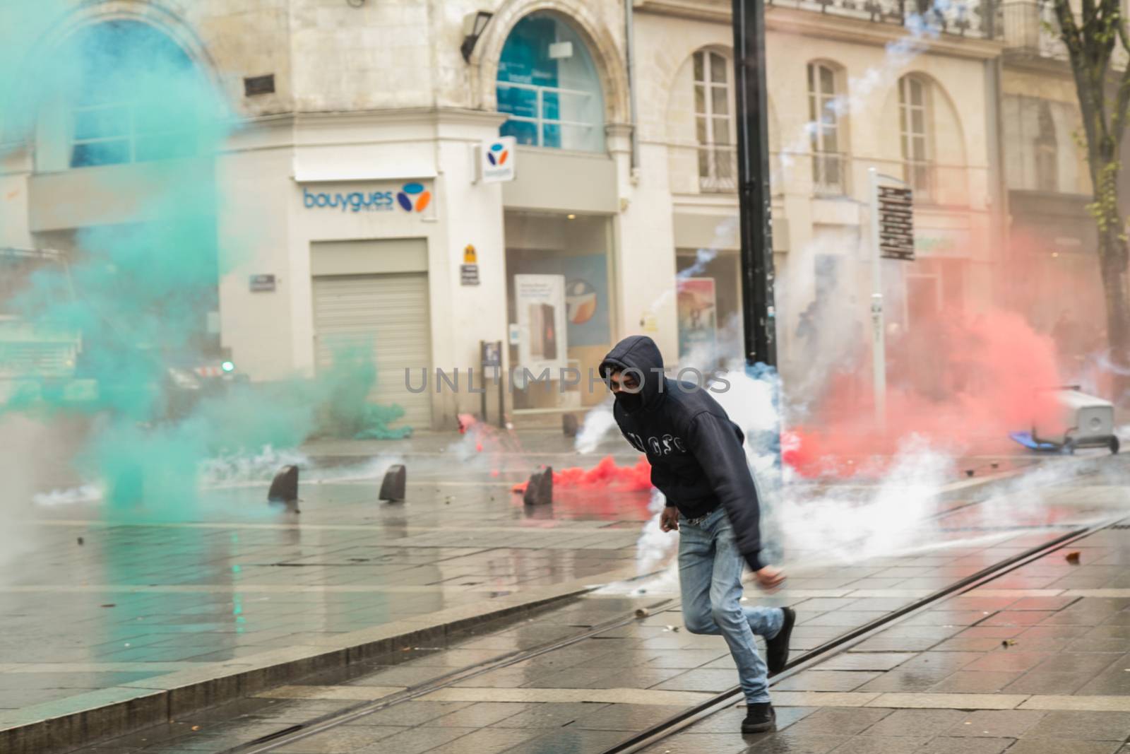 FRANCE, Nantes: A protesters runs during a demonstration on April 9, 2016 in Nantes, western France, against the French government's proposed labour law reforms. Fresh strikes by unions and students are being held across France against proposed reforms to France's labour laws, heaping pressure on President Francois Hollande who suffered a major defeat over constitutional reforms on March 30. 