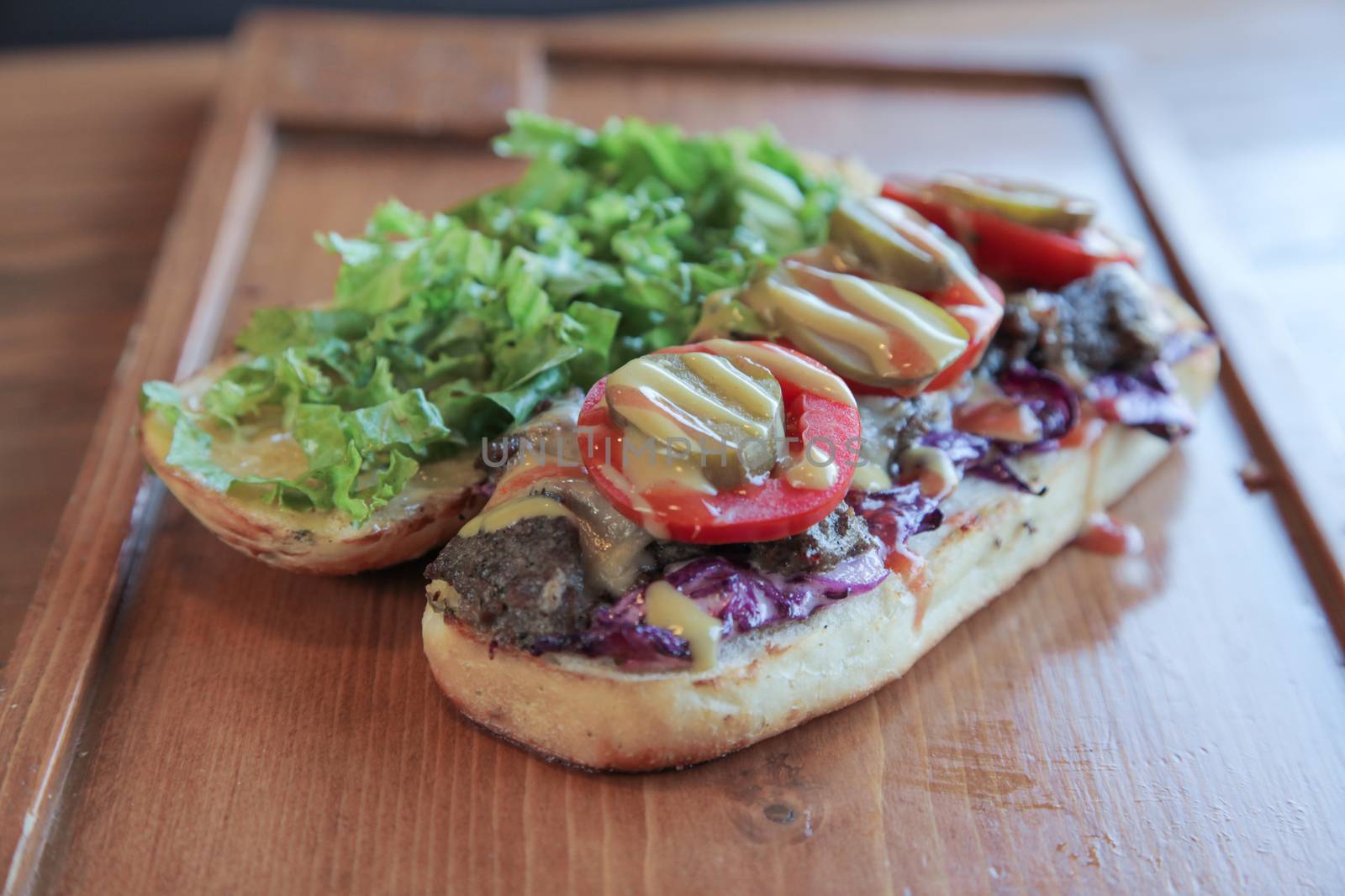 Open faced juicy Steak meaty sandwich filled with vegetables

