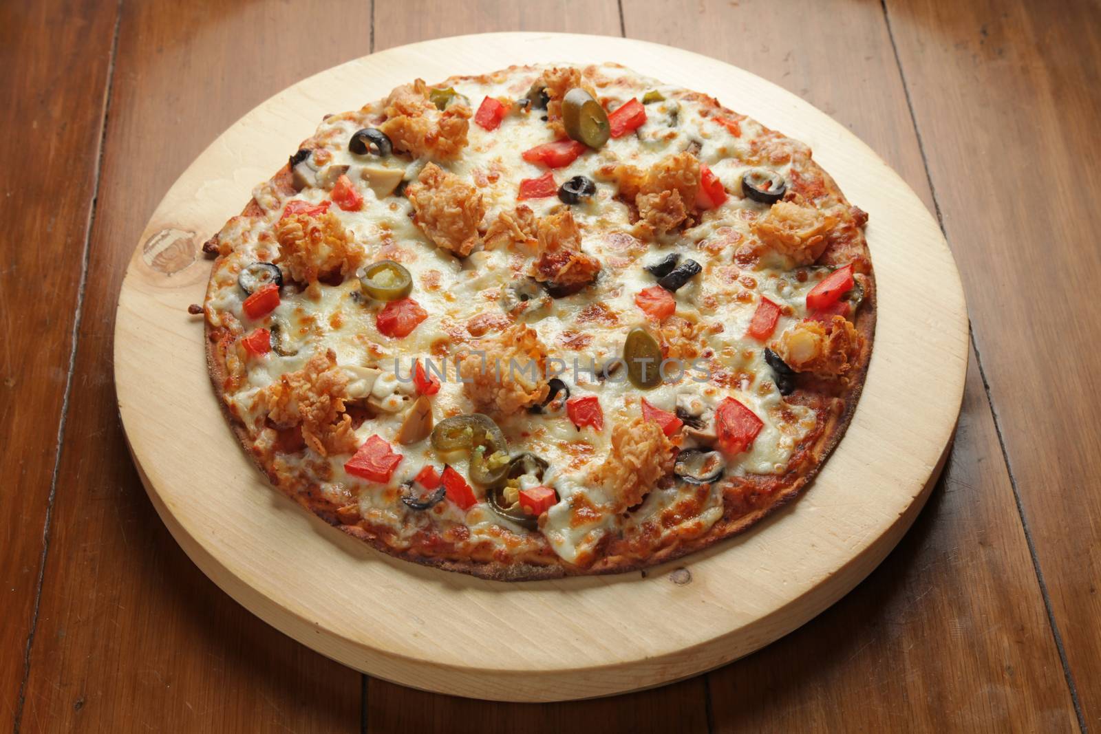 Prawn shrimp flat bread pizza served on a circular wooden board  by haiderazim