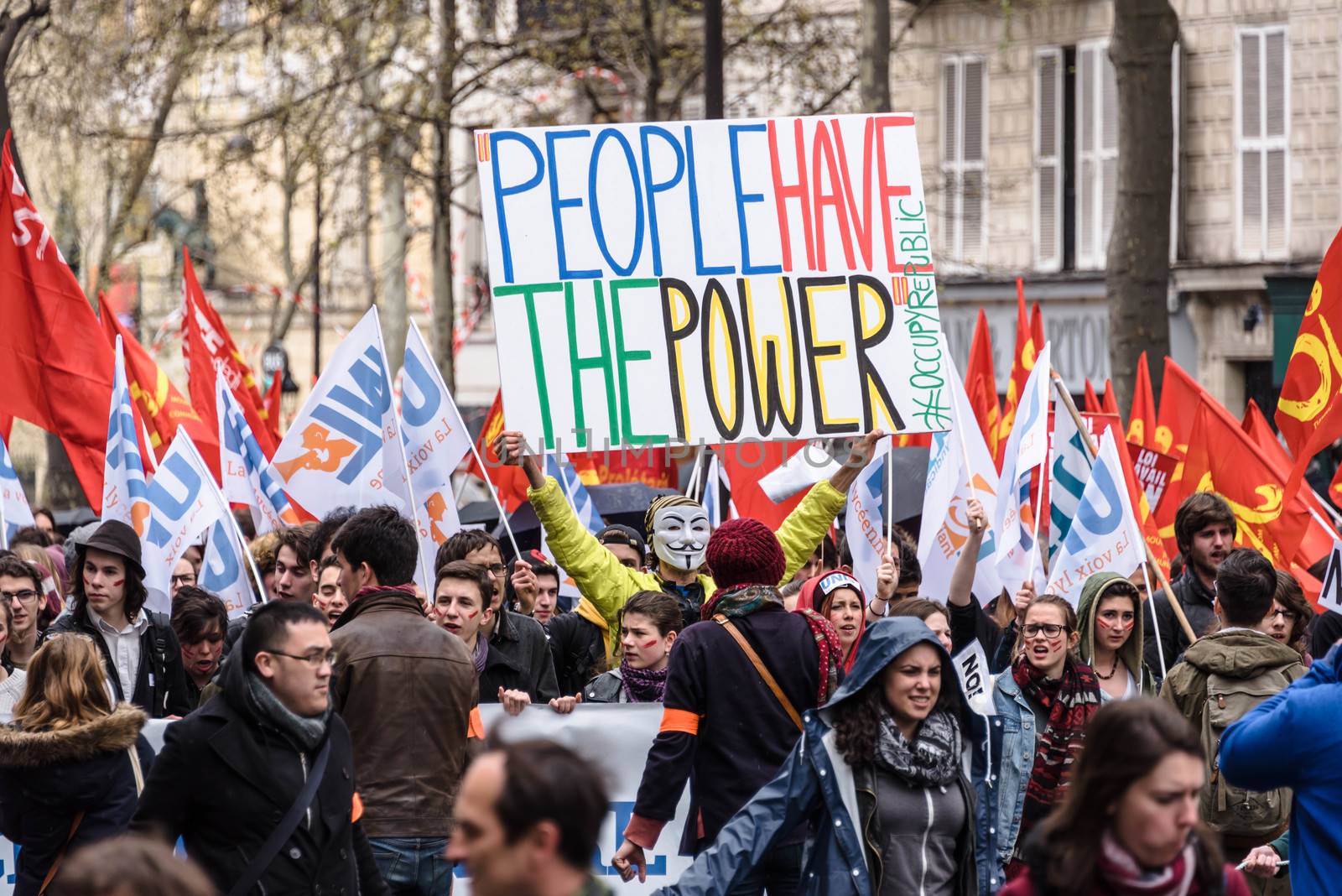 FRANCE, Paris: A demonstrator holds a sign which reads People have the power during a protest on April 9, 2016 in Paris, against the French government's proposed labour law reforms.