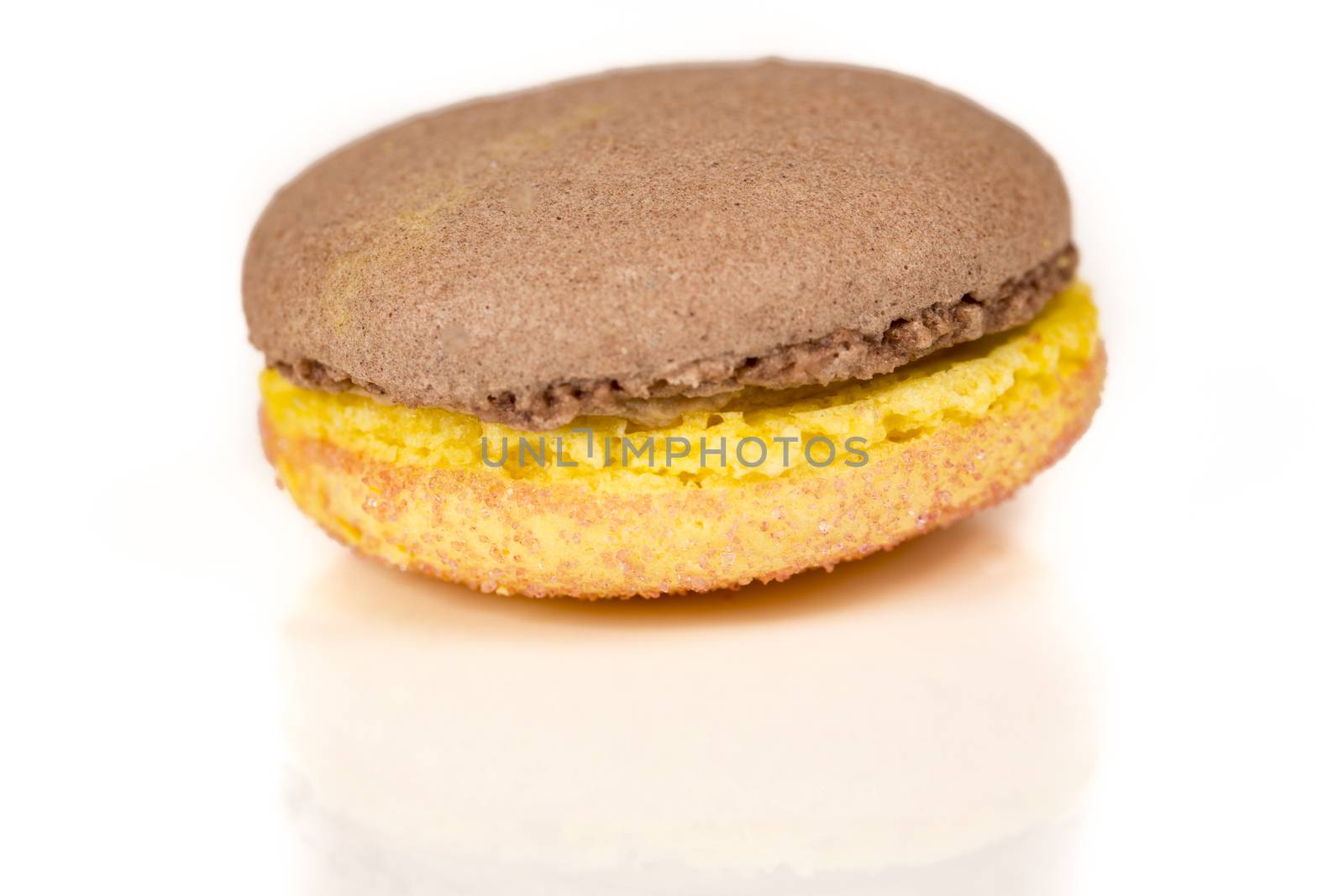 French colorful home made chocolate vanilla macarons on white bakground