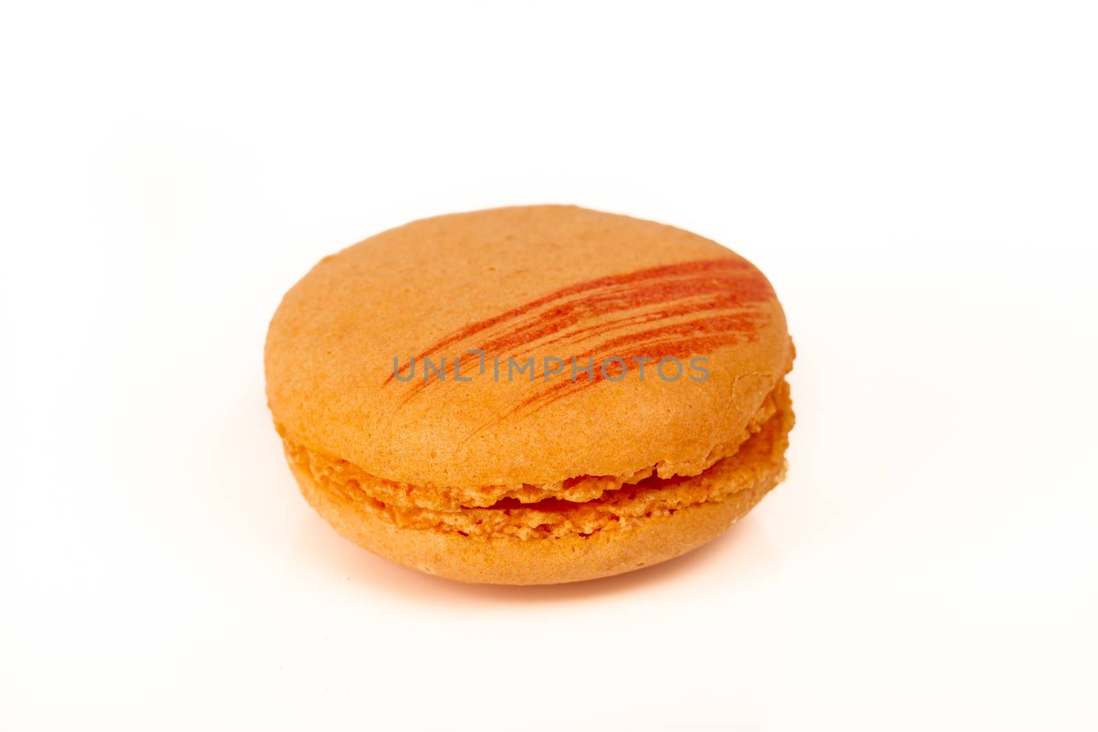 French colorful home made orange macarons  on white bakground