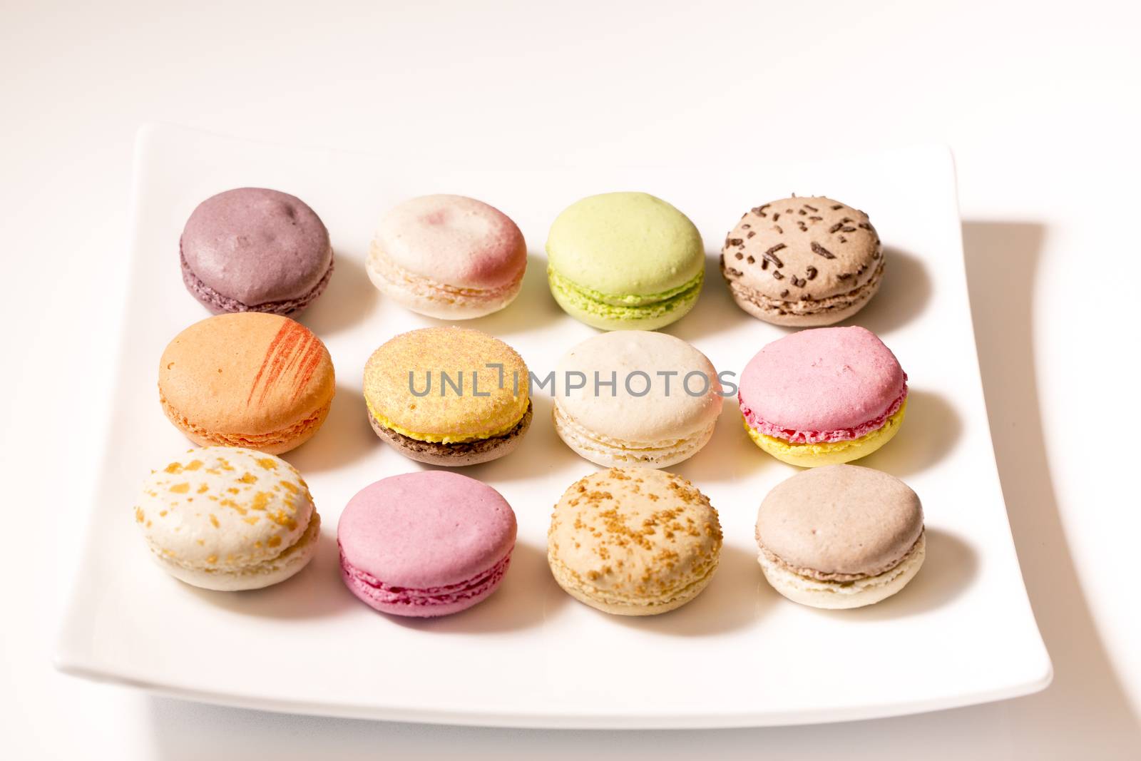 French colorful home made macarons  on white bakground