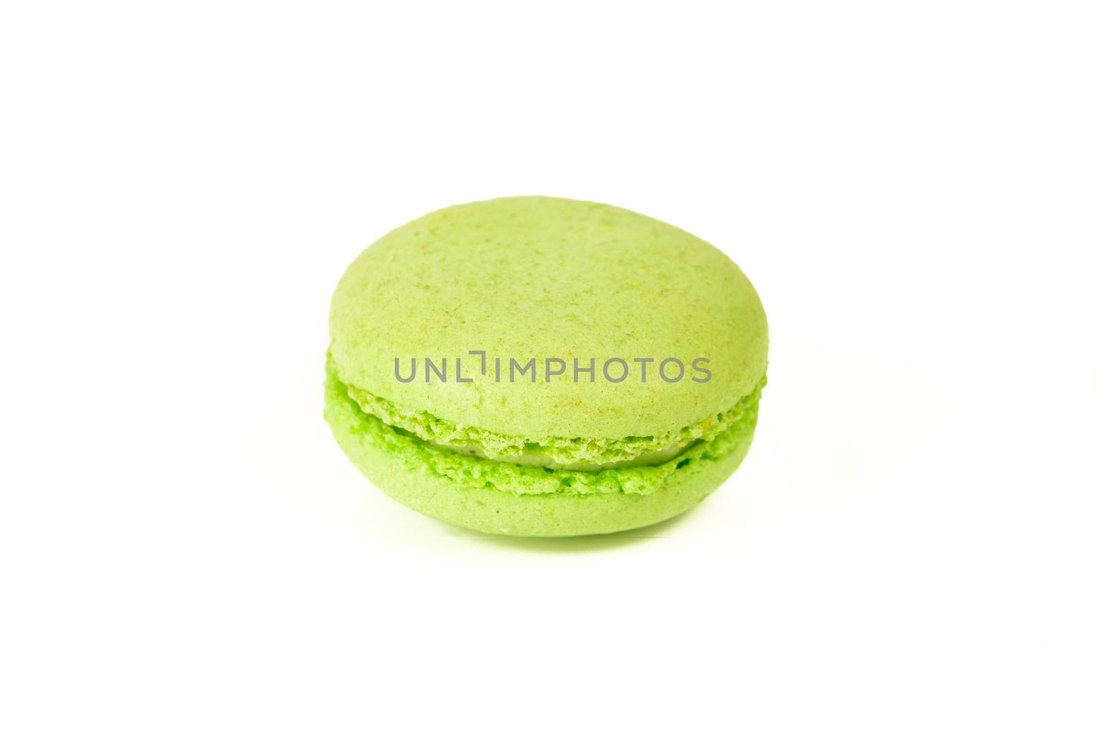 French colorful home made green macarons  on white bakground