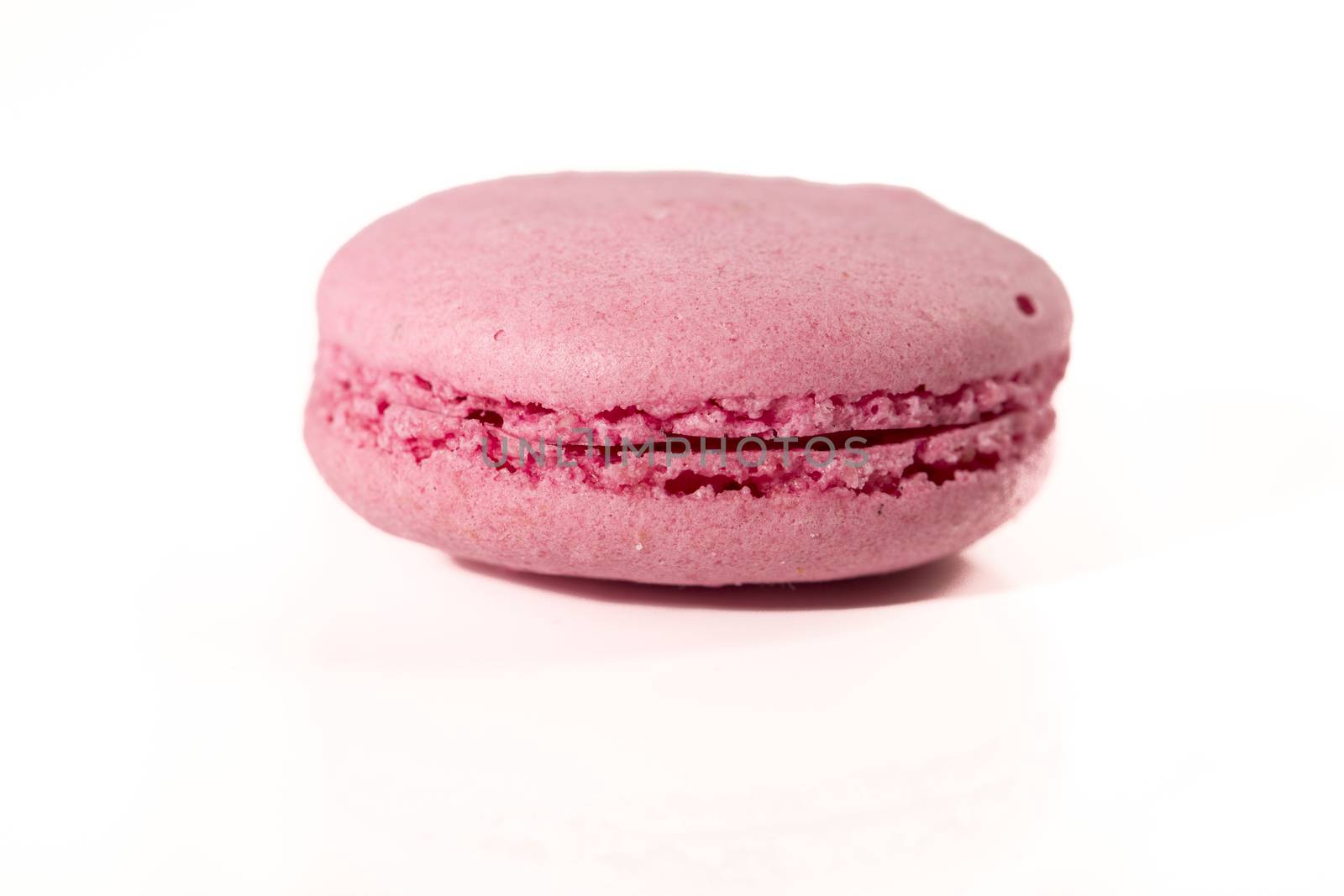 French colorful home made pink macarons  on white bakground