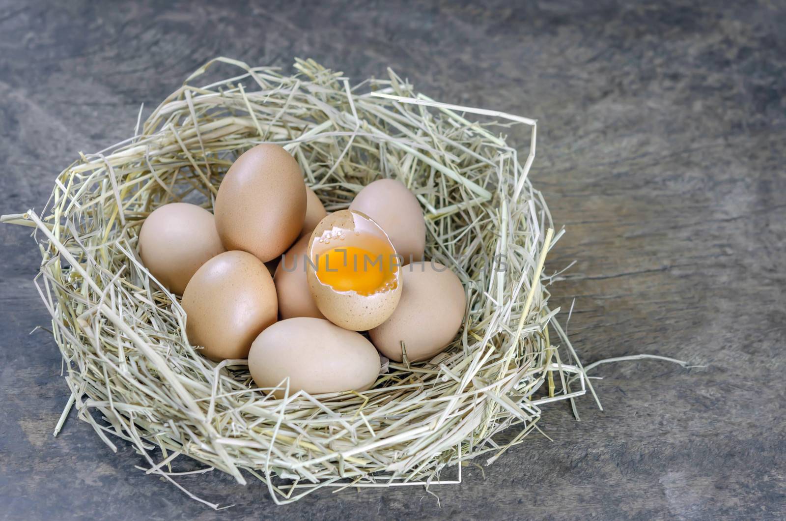 still life brown eggs in nest on  wooden background