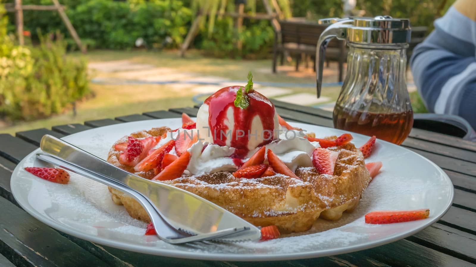 waffles with fresh strawberries and  ice cream on white plate