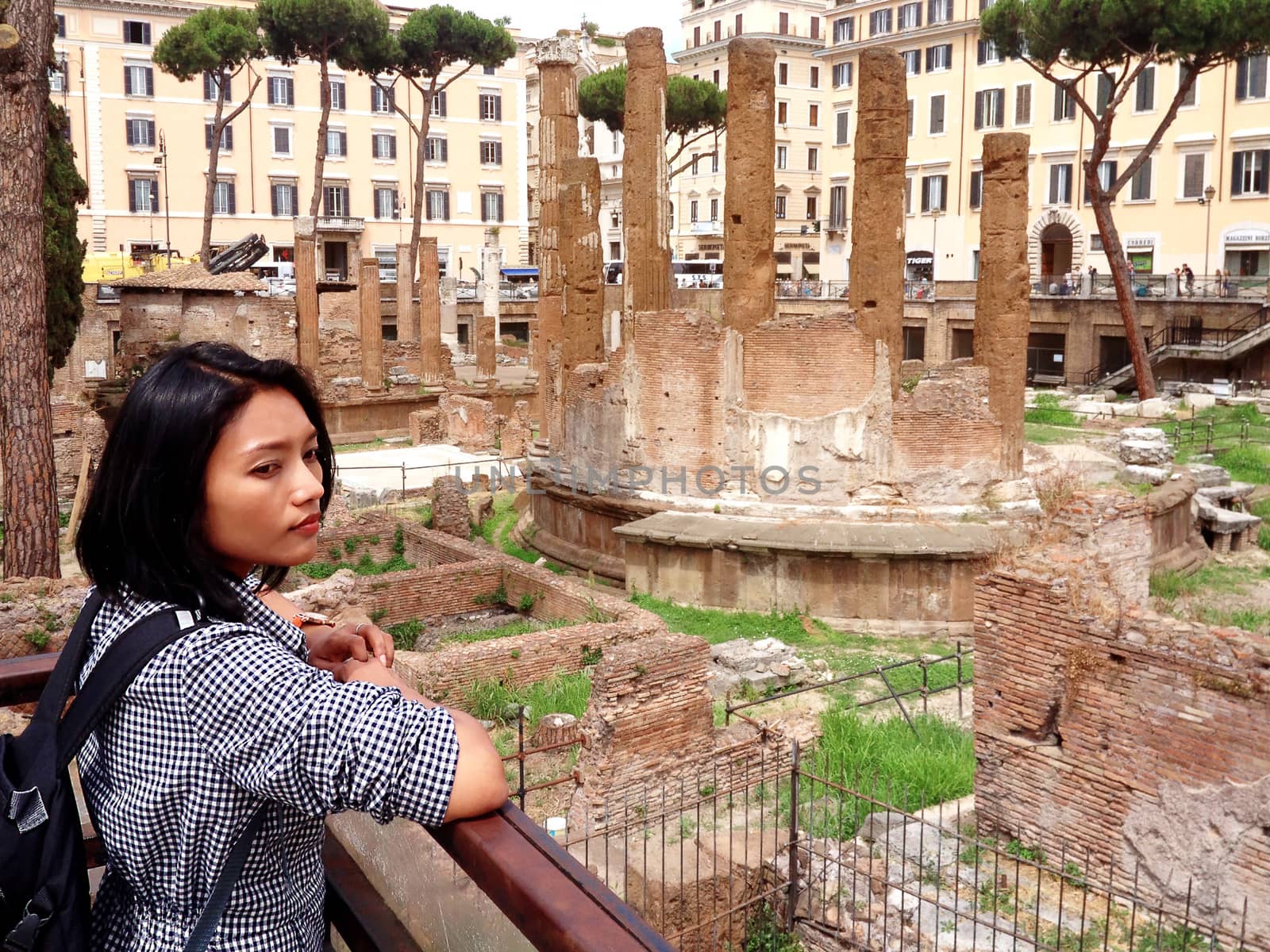 Rome tourists looking at Roman Forum landmark in Rome. Alone sightseeing on travel vacation in Rome, Italy. Woman traveling on holidays in Europe.