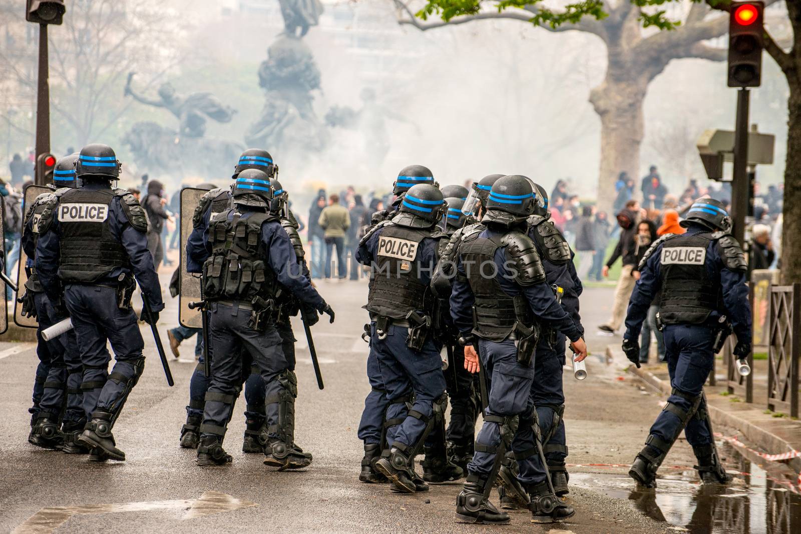 FRANCE, Paris: Riot policemen stand in line in front of violent protesters during a demo on April 9, 2016 in Paris, against the French government's proposed labour law reforms.