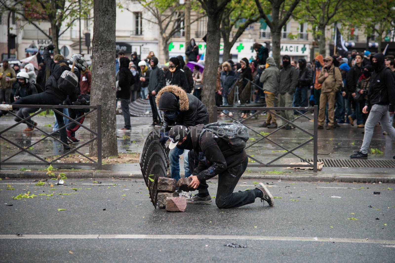 FRANCE, Paris: Protesters collect stones during a demo on April 9, 2016 in Paris, against the French government's proposed labour law reforms.