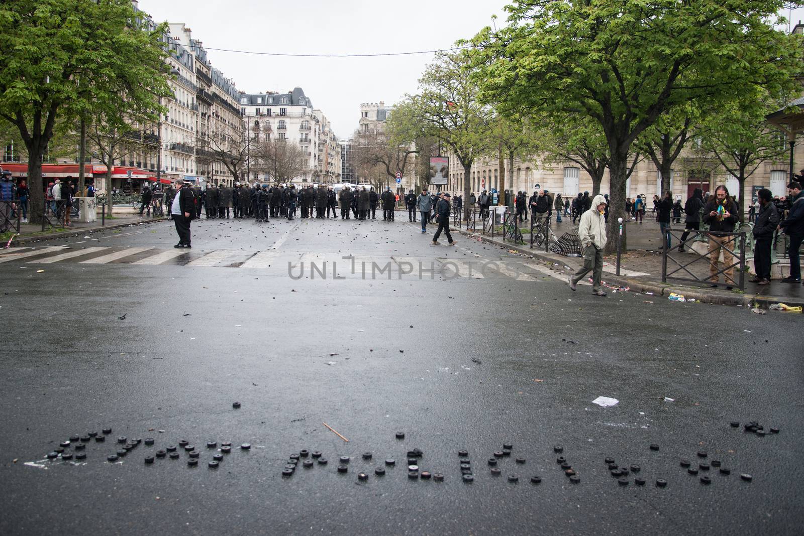 FRANCE, Paris: A picture shows a message written on the ground by protesters Etat policier (police state) during a demo on April 9, 2016 in Paris, against the French government's proposed labour law reforms.