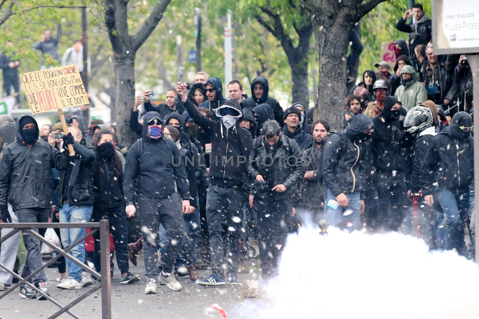 FRANCE, Paris: Masked protesters stand together during a demo on April 9, 2016 in Paris, against the French government's proposed labour law reforms.