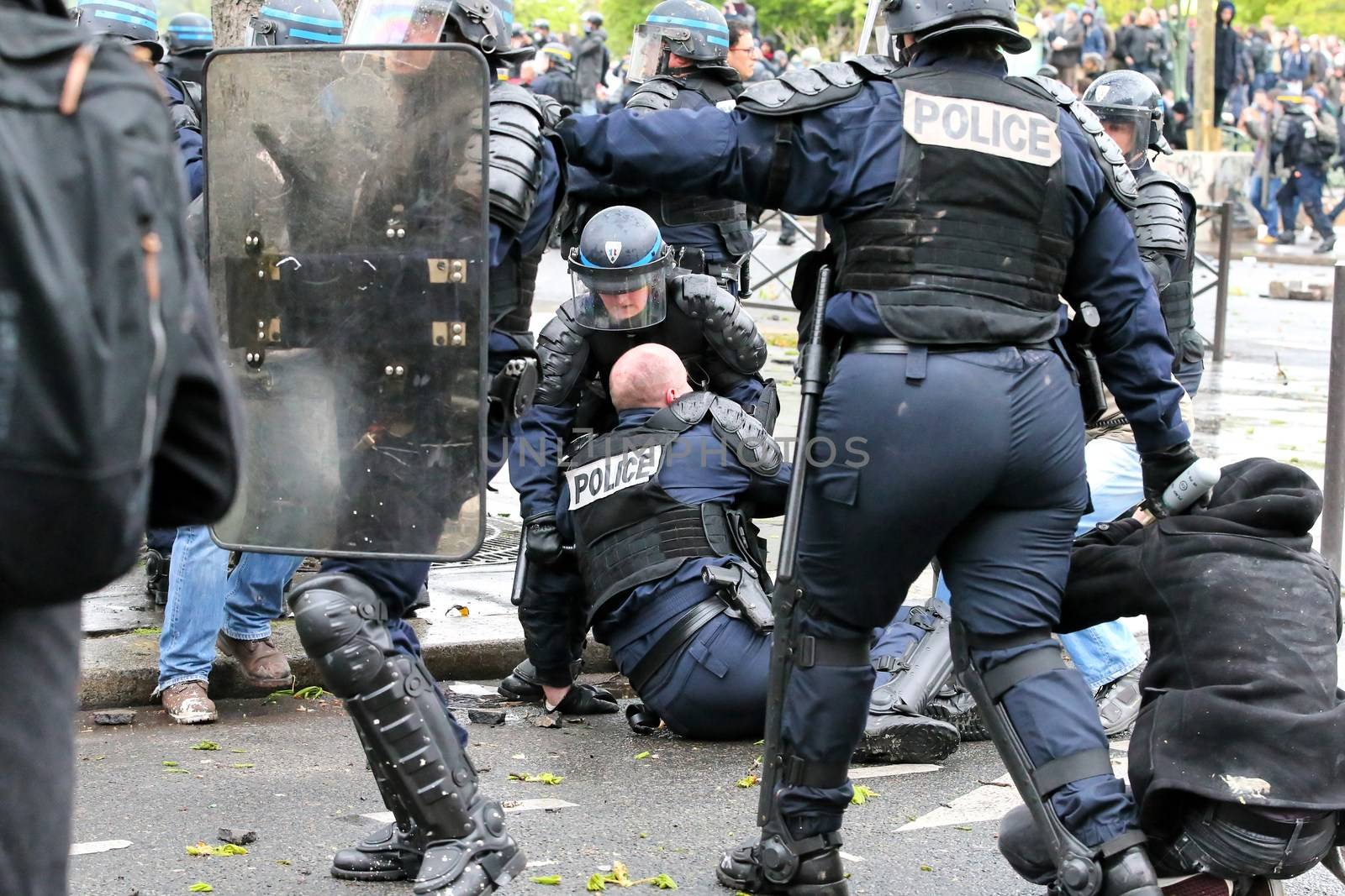FRANCE, Paris: A riot policeman lays on the ground during a demo on April 9, 2016 in Paris, against the French government's proposed labour law reforms.