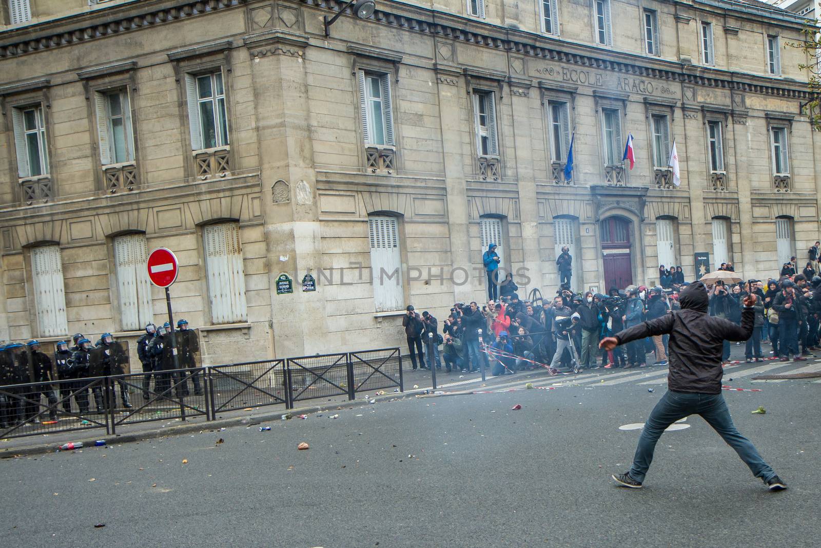 FRANCE, Paris: A protester throws an unidentifiable item to riot policemen during a demo on April 9, 2016 in Paris, against the French government's proposed labour law reforms.