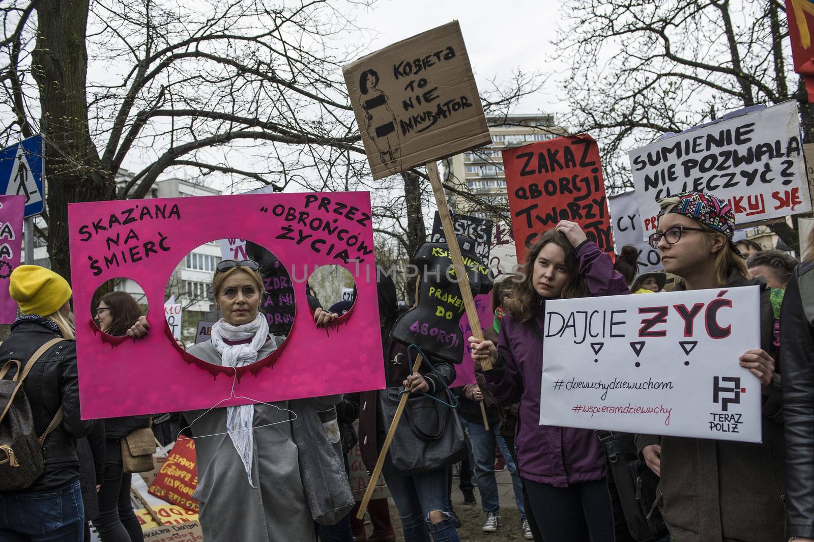 POLAND, Warsaw: People attend an anti-government and pro-abortion demonstration in front of parliament, on April 9, 2016 in Warsaw. The banner reads ' Sentenced to death by 'pro-life defenders'. 