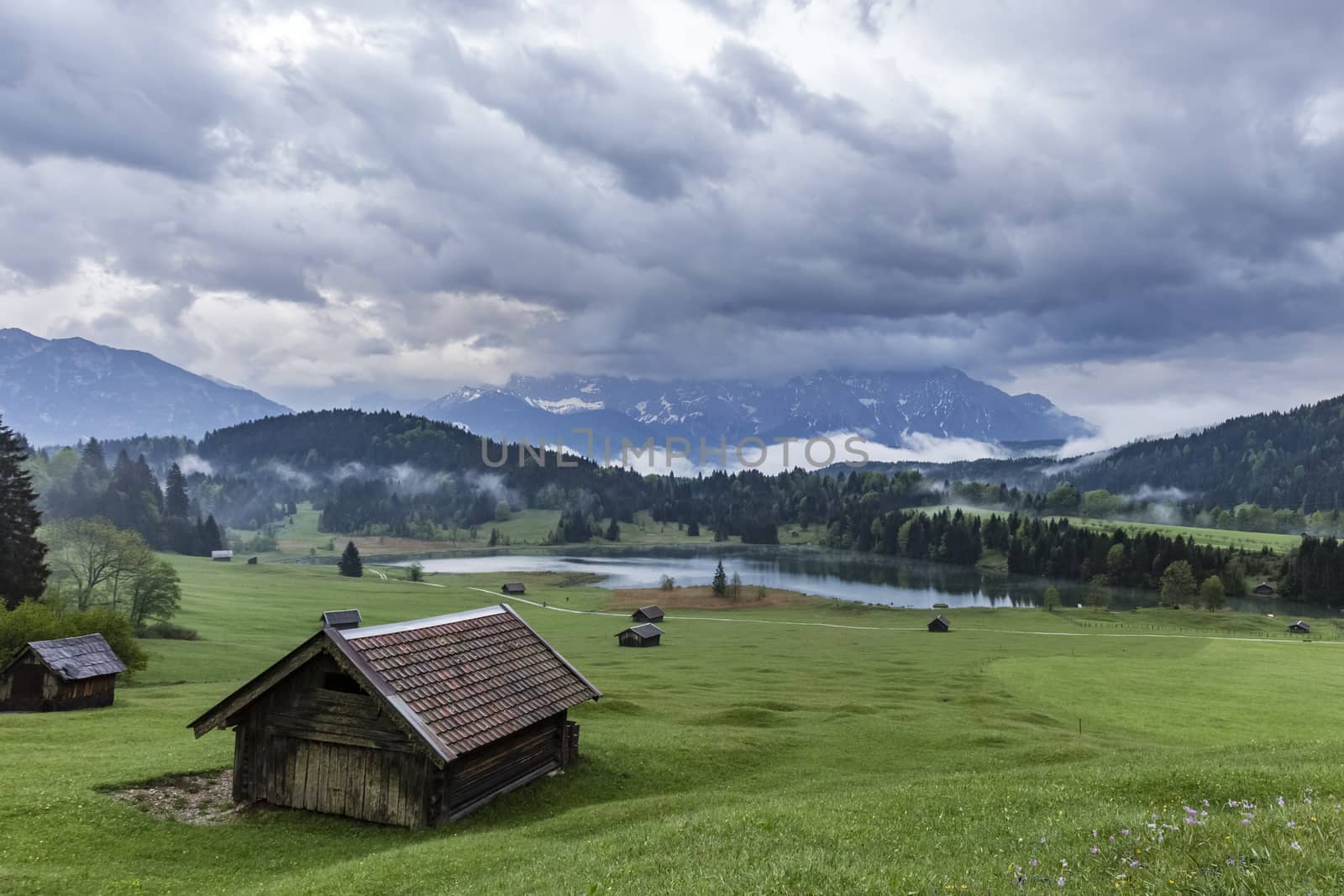 View on Geroldsee in Bavaria from a hill with heavy clouds in the sky