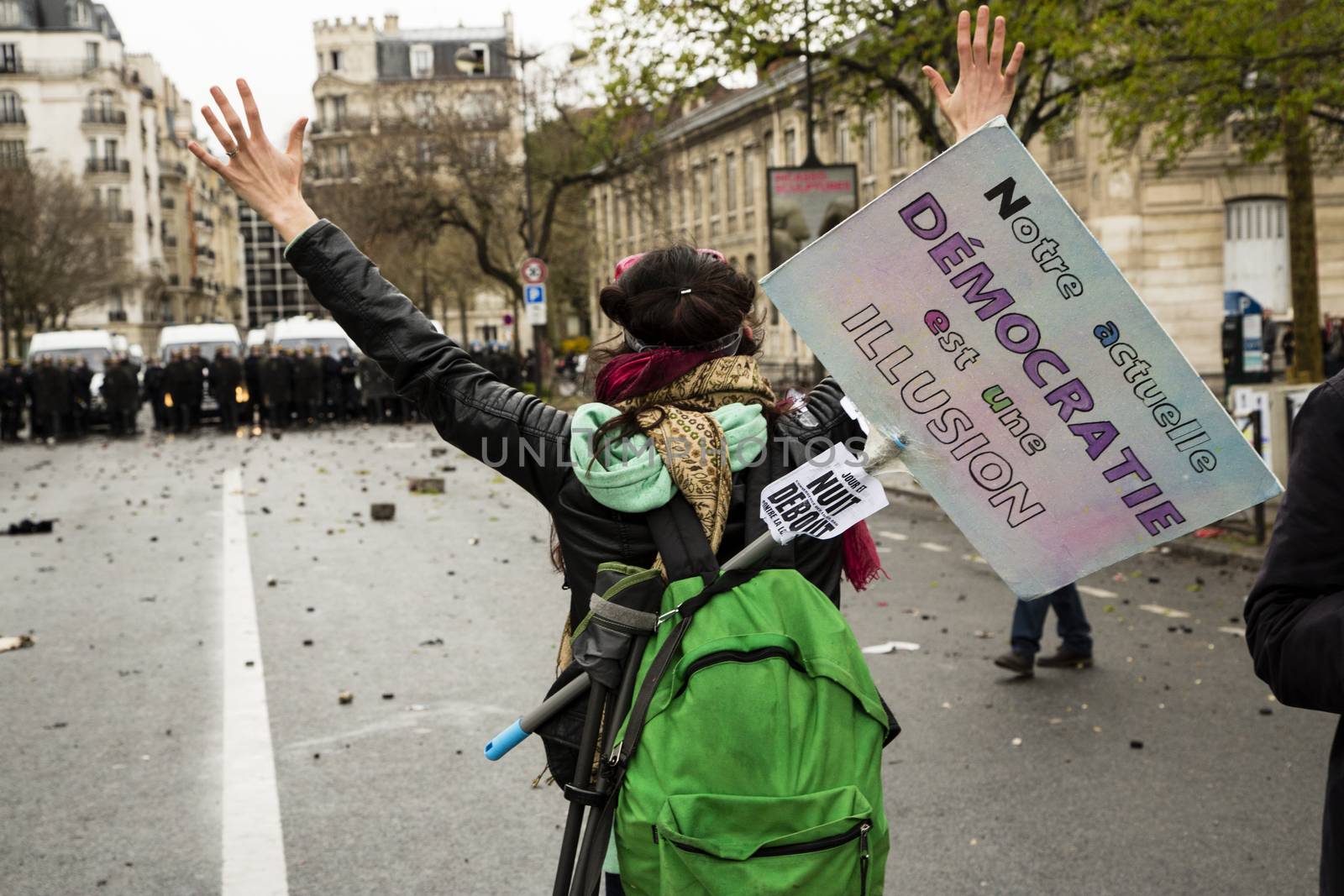 FRANCE, Paris: A protester stands in front of riot policemen at the end of a demonstration against planned labour reforms, in Paris, France, on April 9, 2016.