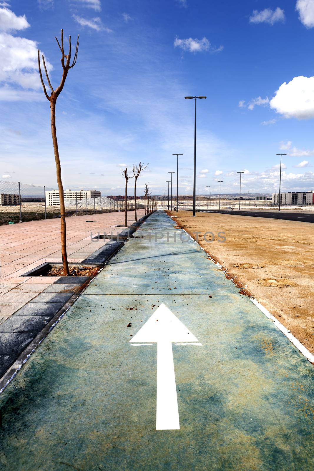 Urban scene. Bike path and blue sky.Sport in the town.