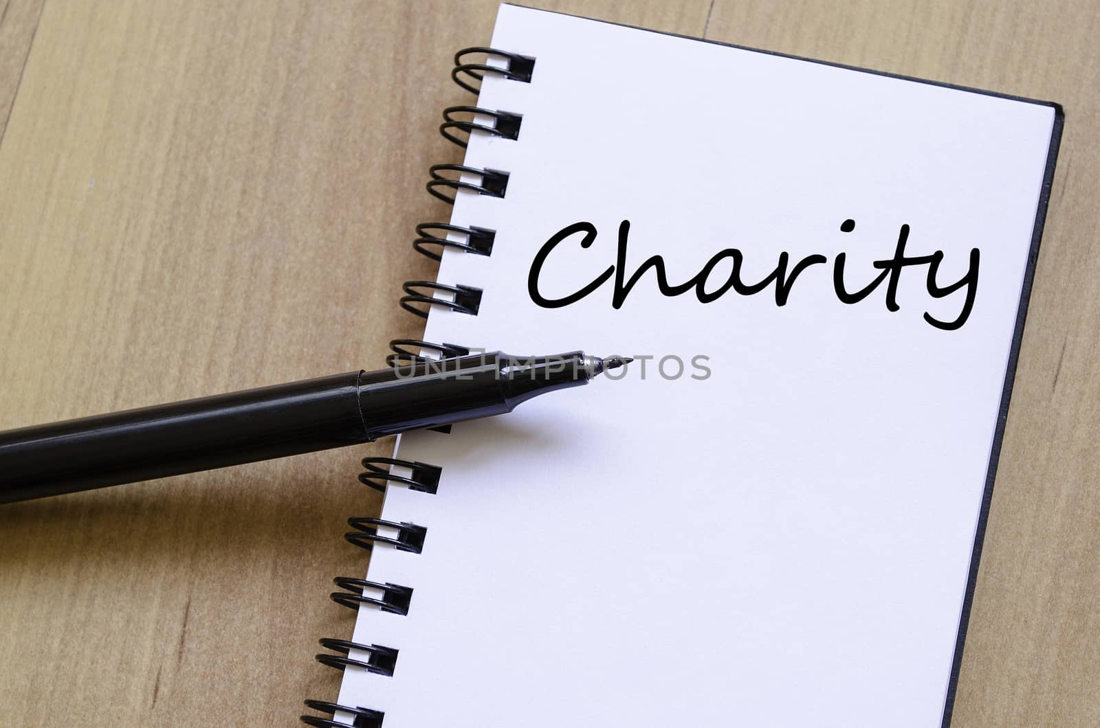 Charity text concept write on notebook