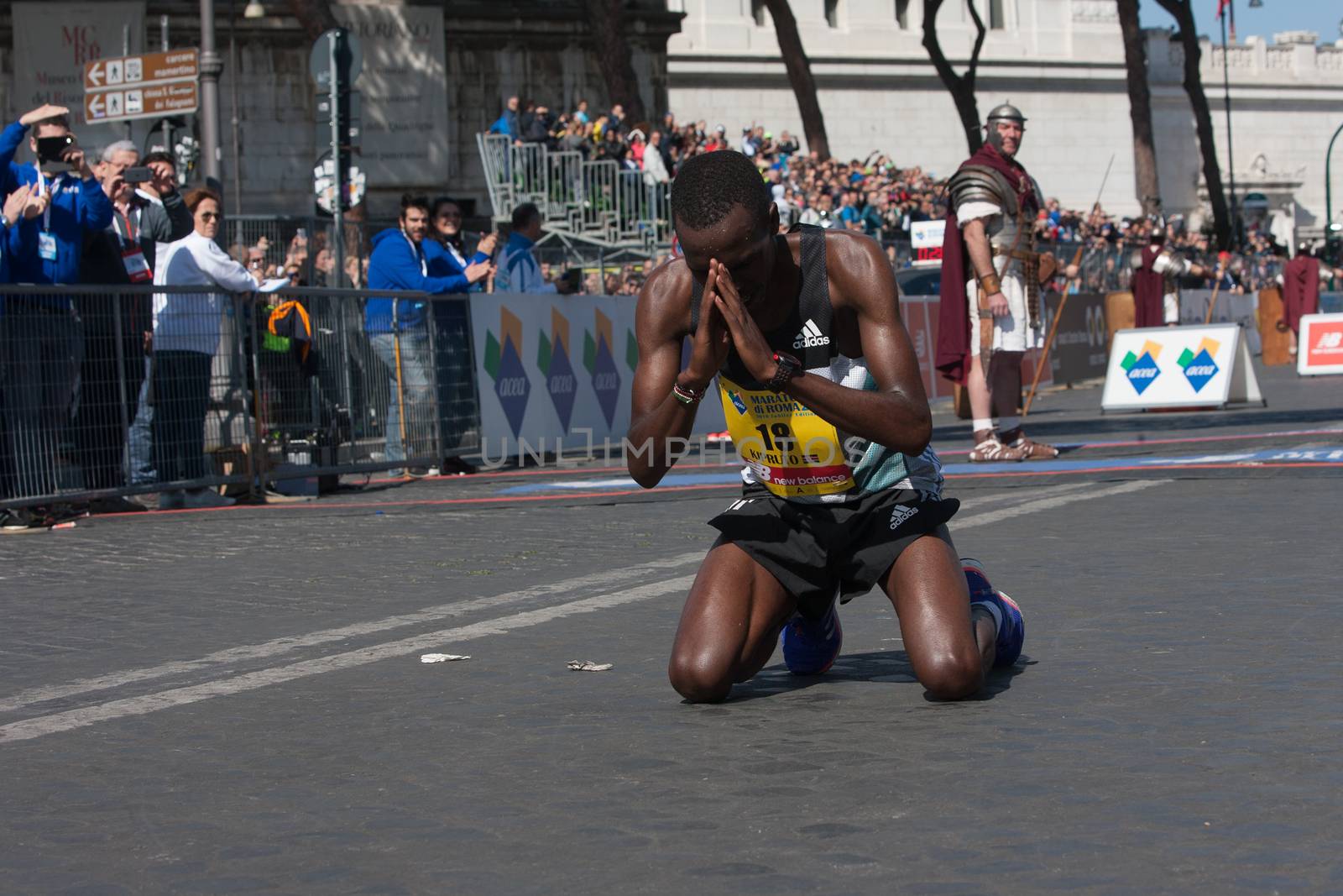 ITALY, Rome: Kenyan runner Amos Kipruto is pictured down on his knees as he won the finish line of Rome City Marathon  in Rome on April 10, 2016. He won the first position in 2h08'16”.