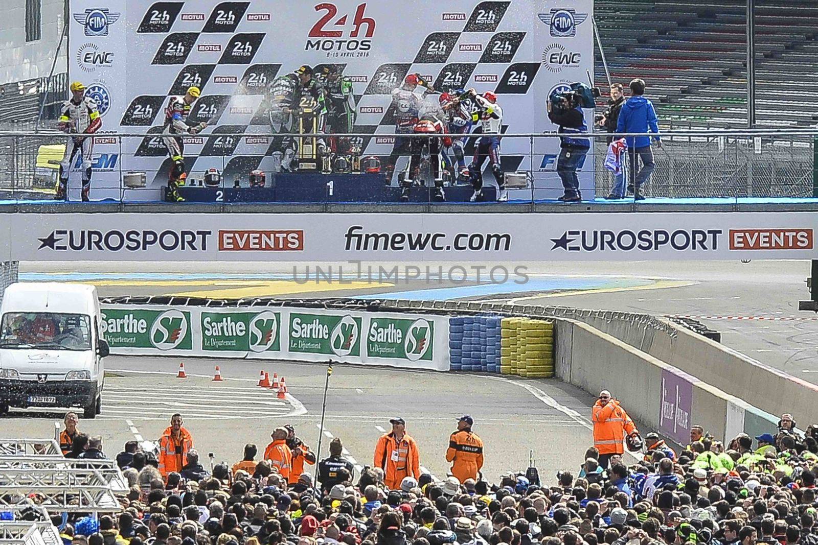 FRANCE, Le Mans: Podium pilots of the 39th edition of Le Mans 24 Hours moto endurance race celebrate over the crowd at Bugatti track in Le Mans, France, on April 9, 2016.
