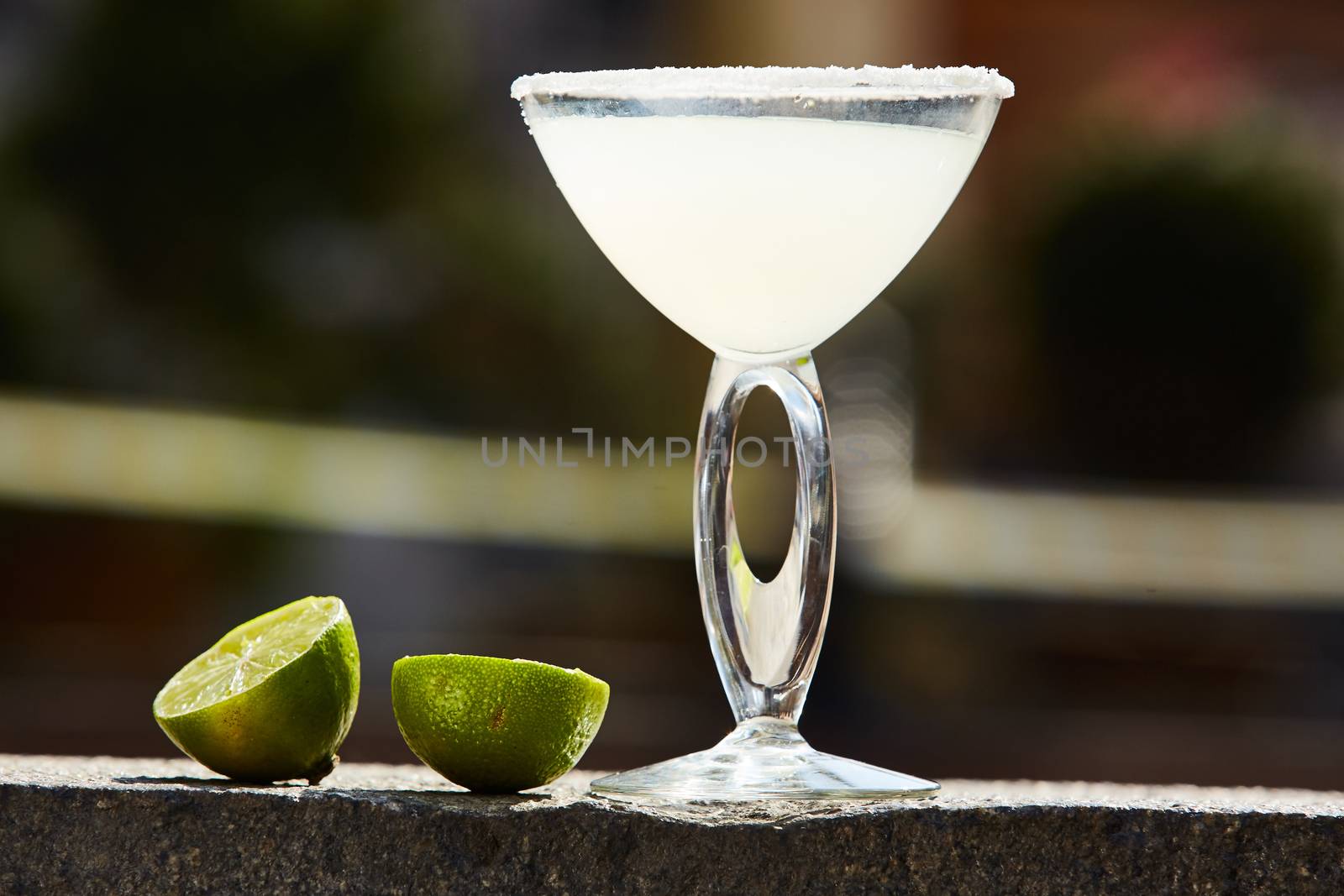 Cocktail in margarita glass with limes. Shallow dof