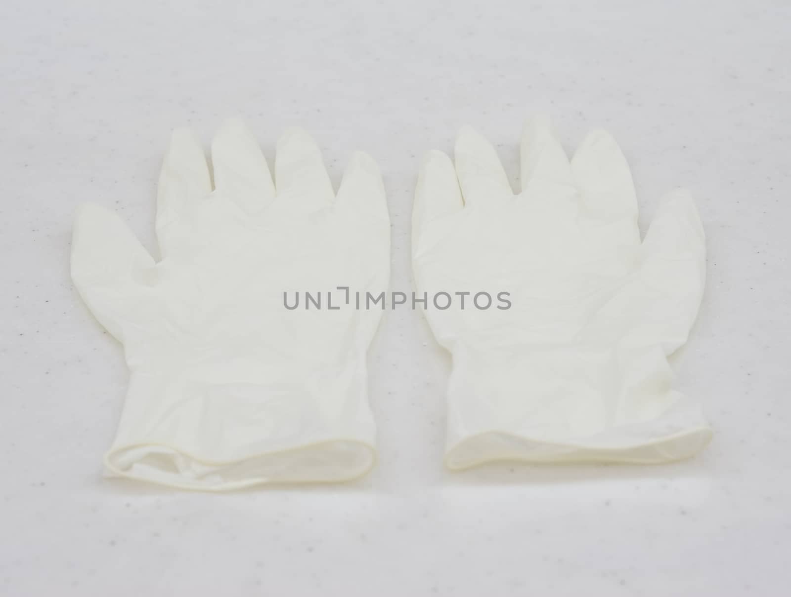 One pair of rubber medical gloves placed on table at patient room.