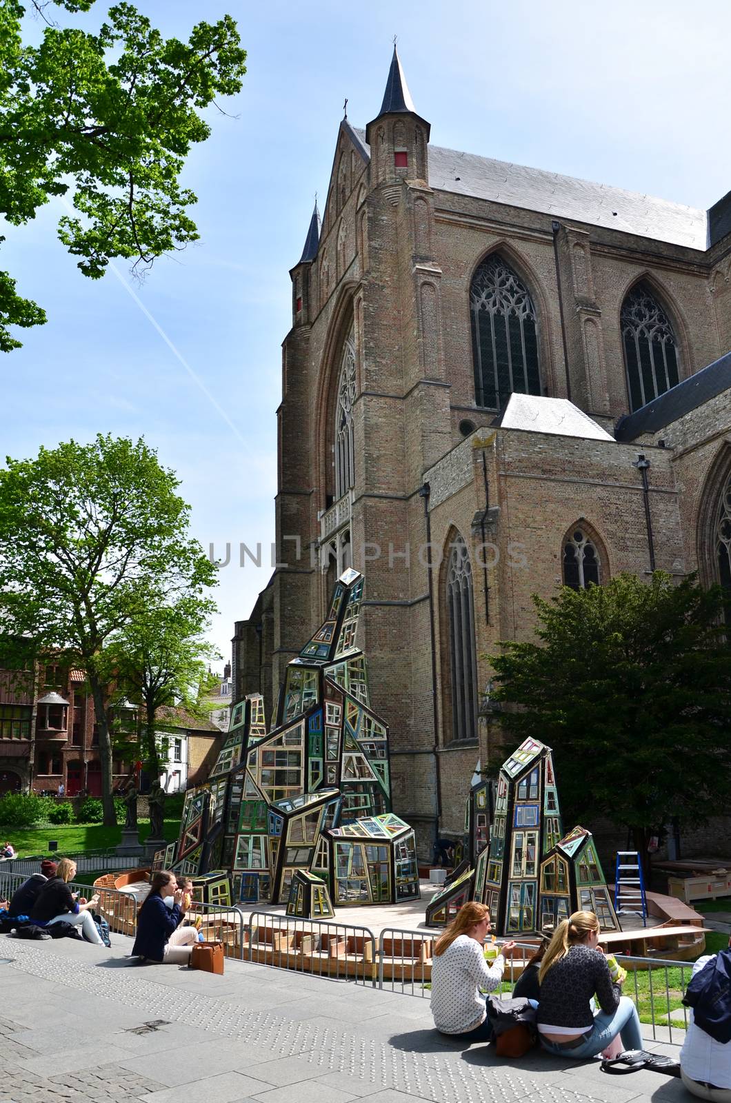 Bruges, Belgium - May 11, 2015: People at the plaza of St. Salvator's Cathedral in Bruges by siraanamwong