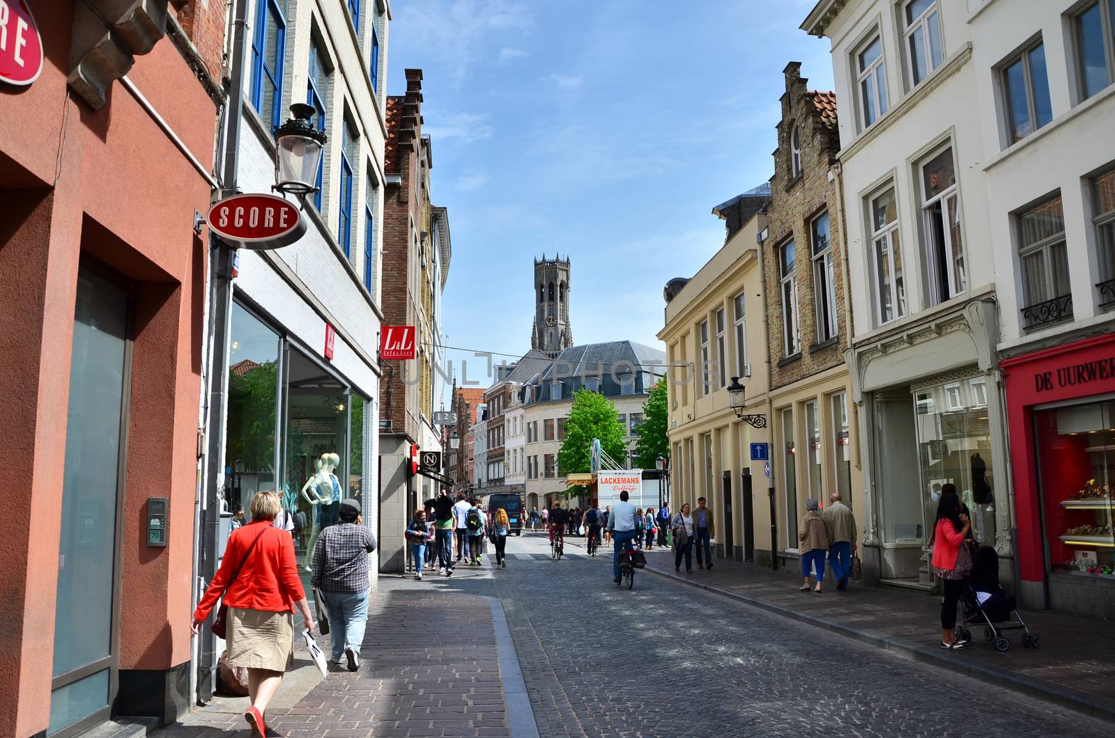 Bruges, Belgium - May 11, 2015: Tourists visit Steenstraat Shopping Street in Bruges, Belgium. Bruges is the capital and largest city of the province of West Flanders in the Flemish Region of Belgium.