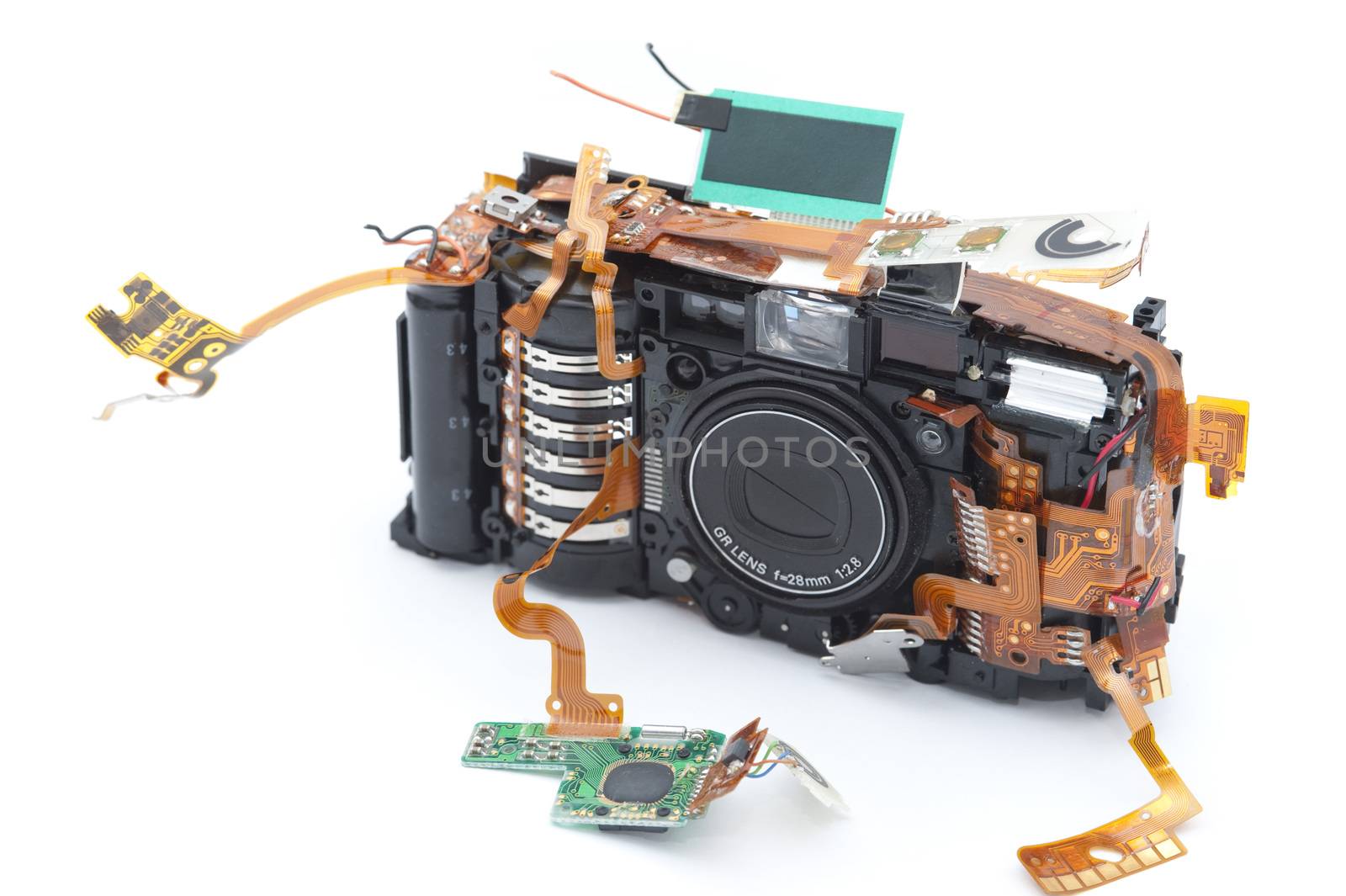 Disassembled digital camera with exposed copper ribbons attached to green soldered micro board
