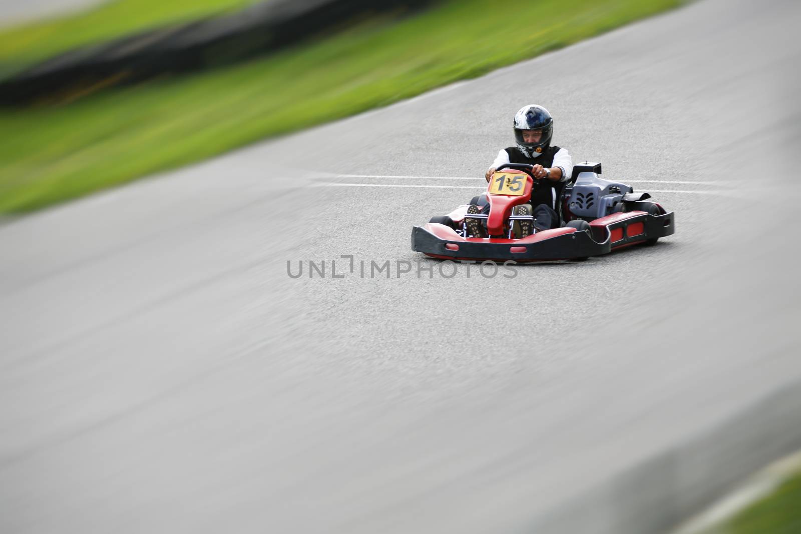 go-kart pilot is racing a race in an outdoor go karting circuit 