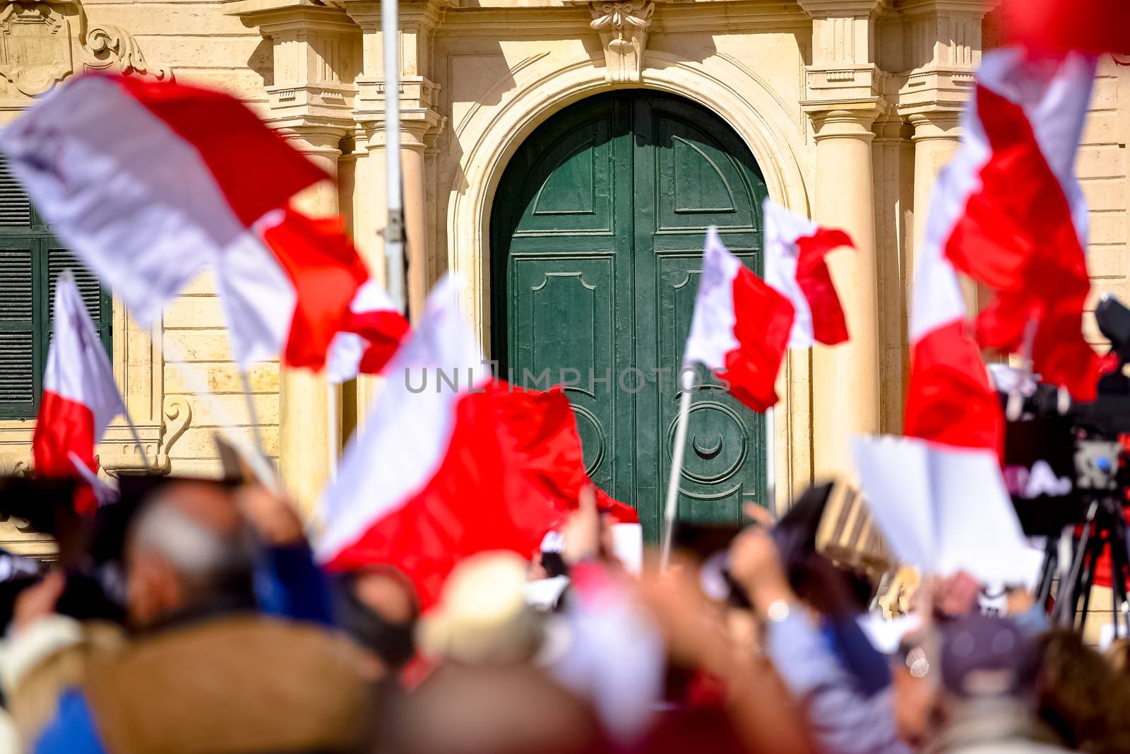 MALTA, Valletta: Protestors wave Maltese flags during a demonstration calling on Maltese Prime minister Joseph Muscat to resign after two members of his government were named in the Panama Papers leak scandal, outside the office of the Prime minister in Valletta, in Malta, on April 10, 2016. 