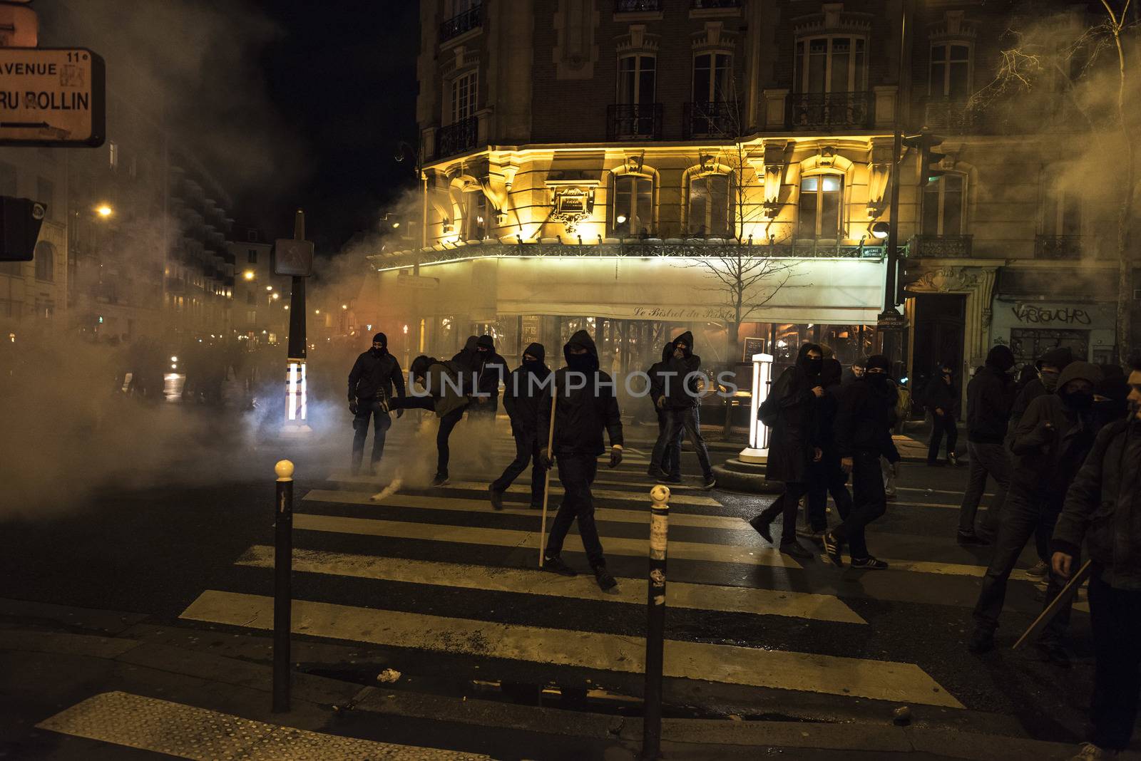 FRANCE, Paris: Riot policemen use tear gas to contain Nuit Debout militants in Avenue Ladru-Rollin in Paris, as they want to reach French Prime minister Manuel Valls residence on April 9, 2016. 
