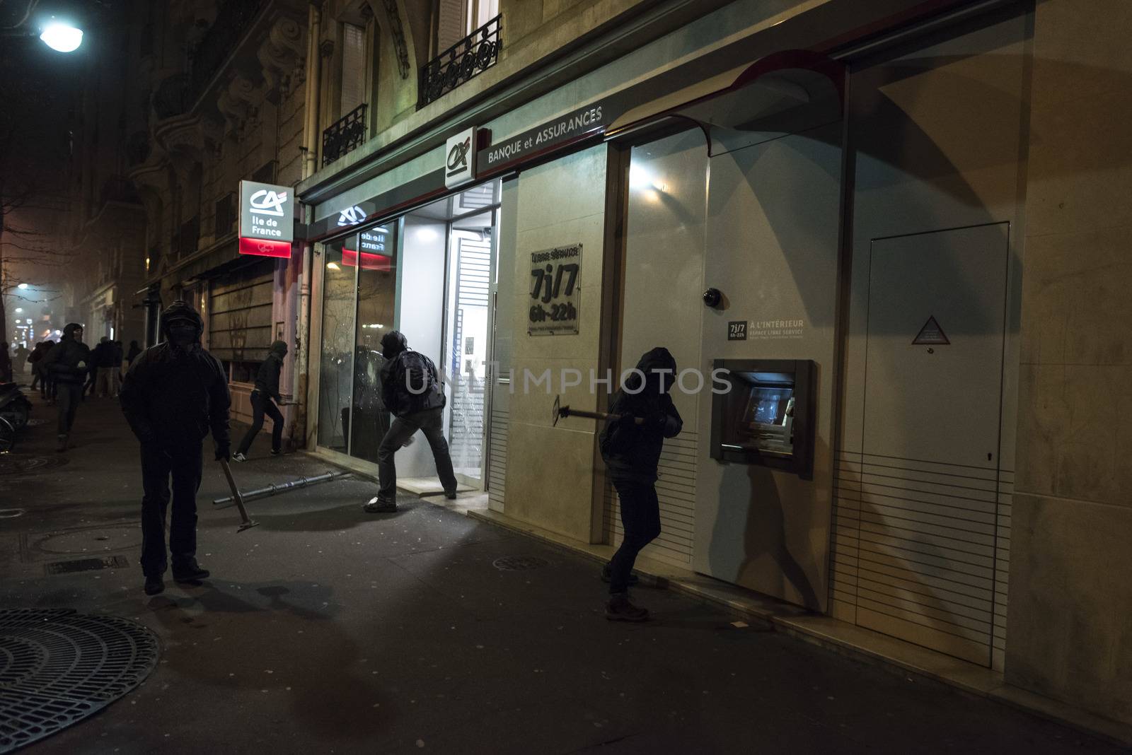 FRANCE, Paris: Troublemakers wreck the front window of a Credit-Agricole bank as Nuit Debout militants demonstrate in Paris, to reach French Prime minister Manuel Valls residence on April 9, 2016. 