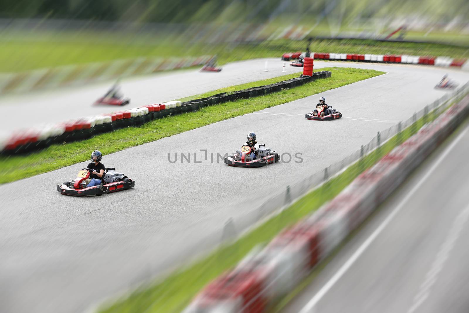 go-kart pilot is racing a race in an outdoor go karting circuit 