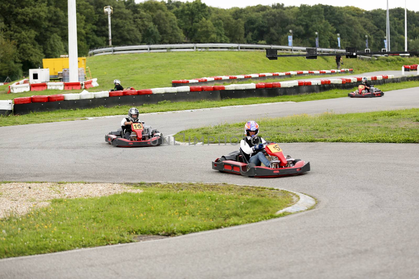 go-kart pilot is racing a race in an outdoor go karting circuit 