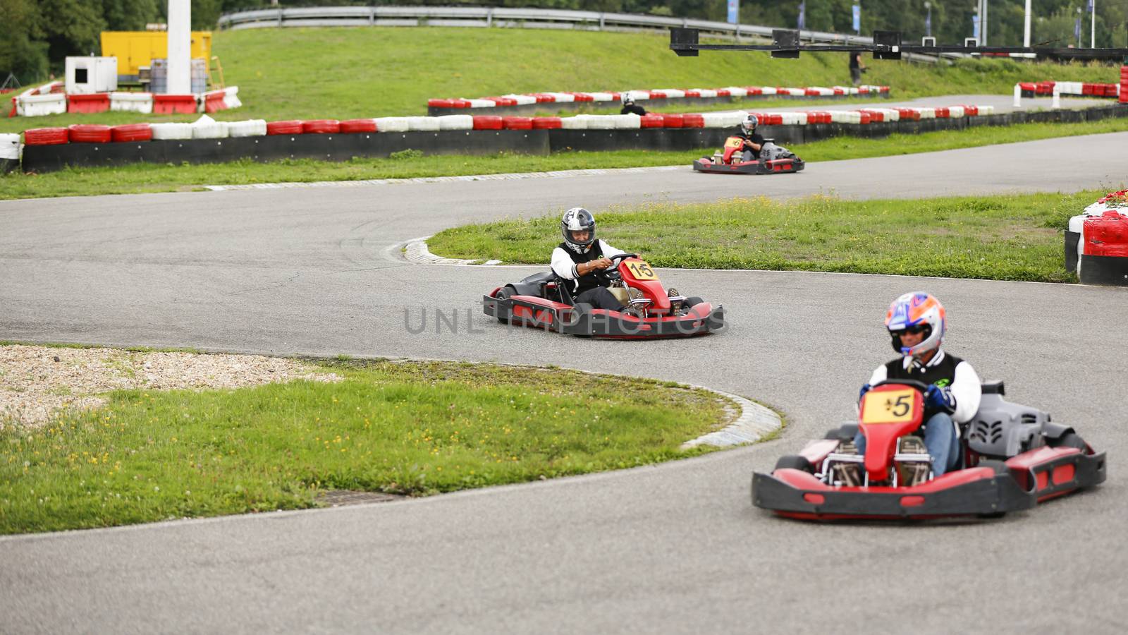 go-kart pilot is racing a race in an outdoor go karting circuit 