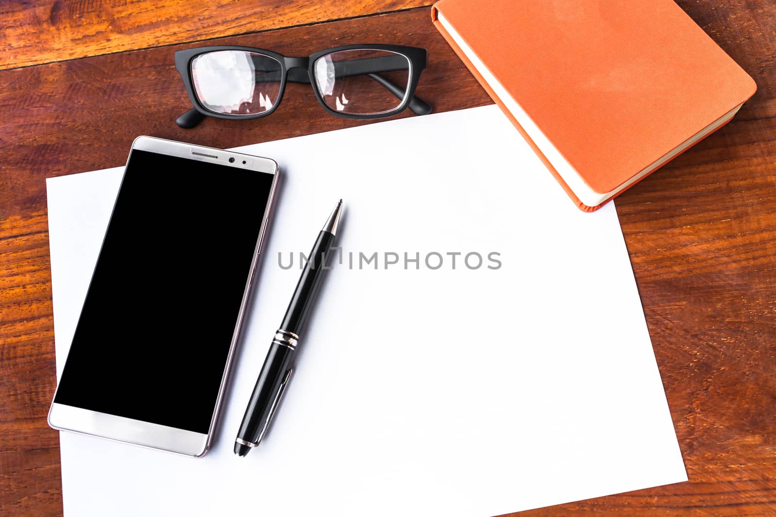 Blank paper with pen and smartphone on wood table concept and Id by nopparats